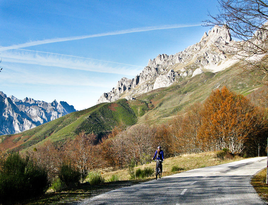 A biker on a cycling Spain tour of Picos de Europa climbing up the road