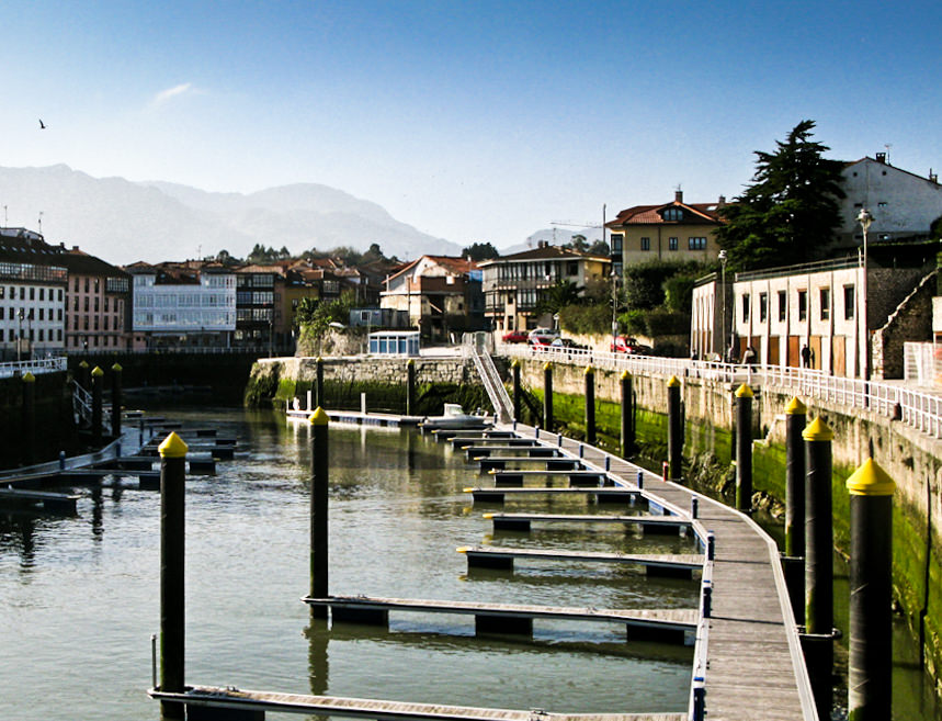 A town with a river and docks for boats in Asturias