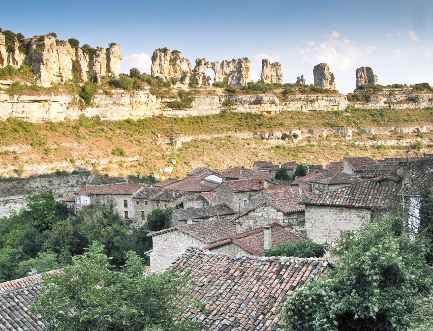 Orbaneja del castillo Karst rocks with red roof of some houses