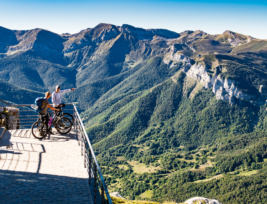 Two mountain bikers sightseeing Picos de Europa mountains
