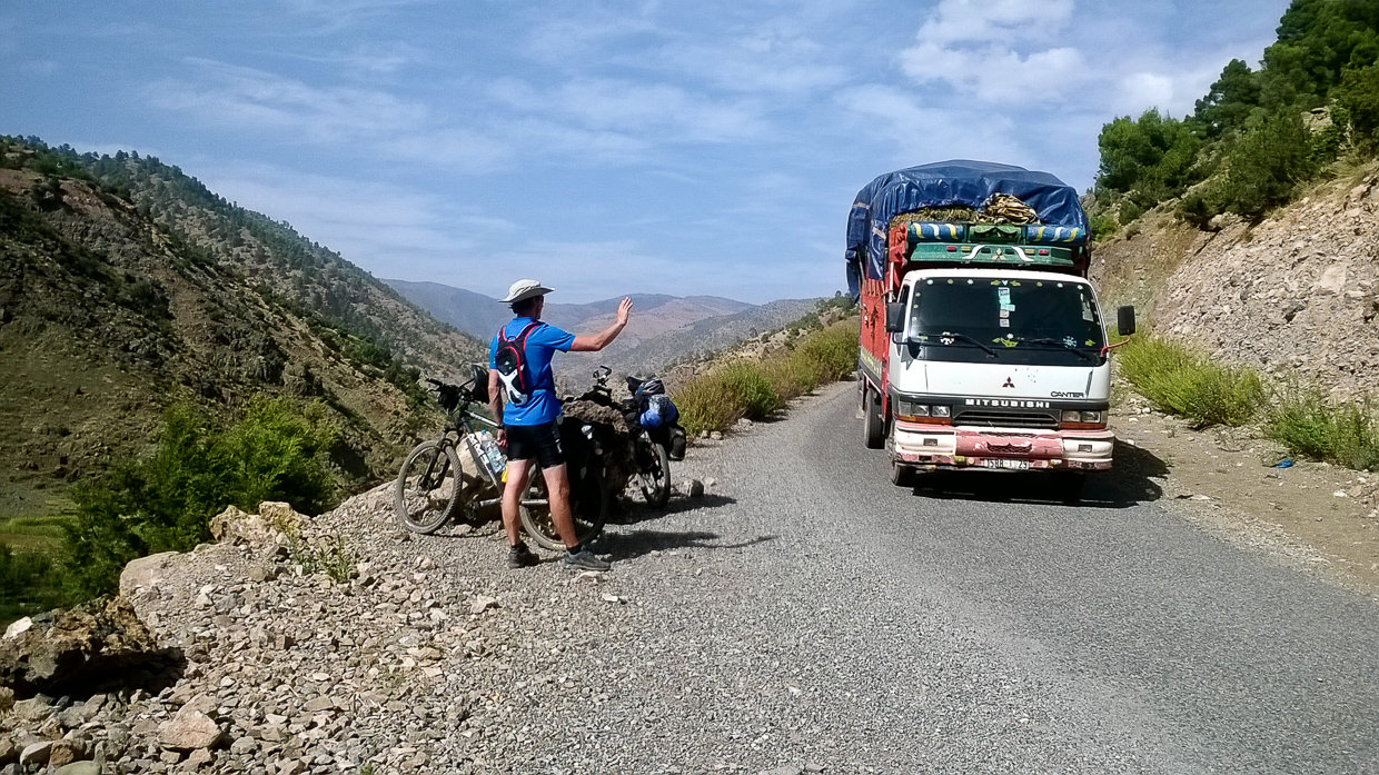 A biker saying hello to a driver in Atlas mountains