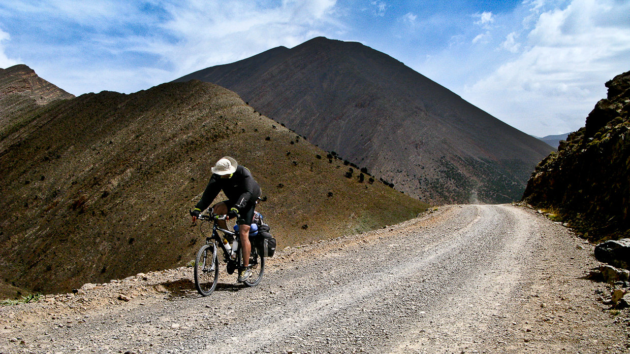 Mountain biker cycling up the hill in Atlas