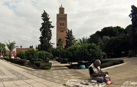 A man sitting in front of a Marrakesh mosque